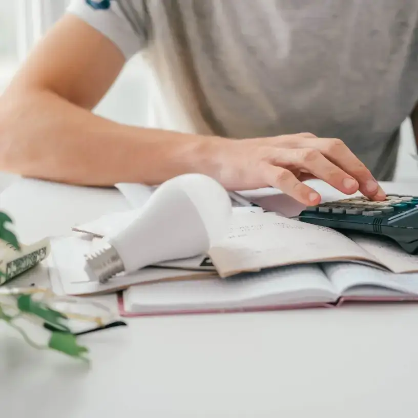 Person calculating their energy bills before switching providers